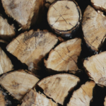 A close-up of stacked firewood featuring various logs